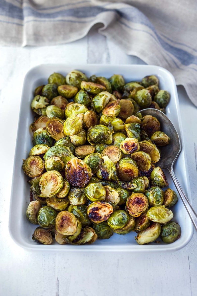 A simple recipe for Roasted Brussels Sprouts with garlic and balsamic- tender, carmelized and full of toasty deep flavor.  An easy vegan side dish ready in 30 minutes! 