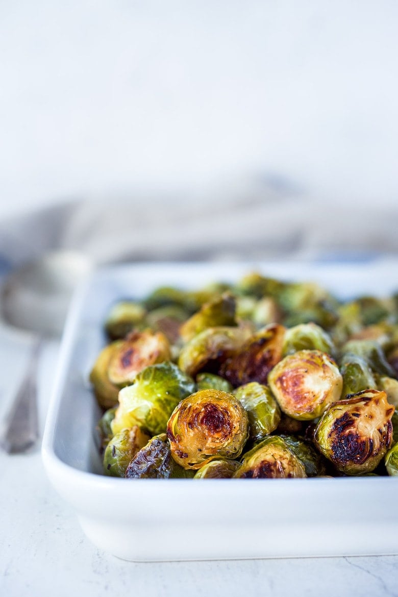 A simple recipe for Roasted Brussels Sprouts with garlic and balsamic- tender, carmelized and full of toasty deep flavor.  An easy vegan side dish ready in 30 minutes! 