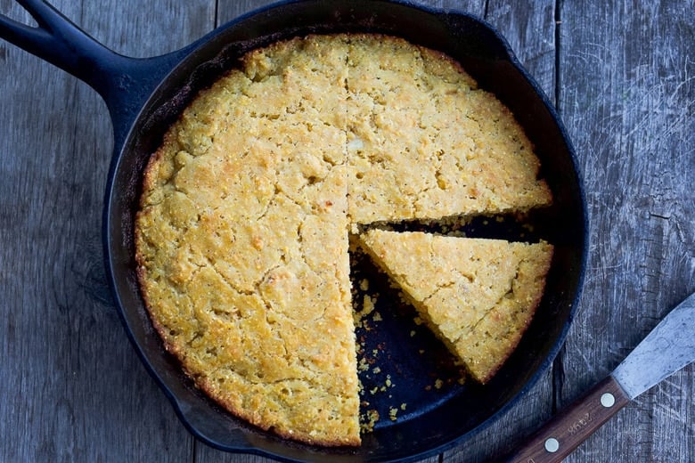 Hearty Skillet Cornbread is homey, delicious, and full of wholesome cornmeal flavor with an irresistible crusty edge.  Super easy to make!  Perfect for serving with soups, chili's, stews.