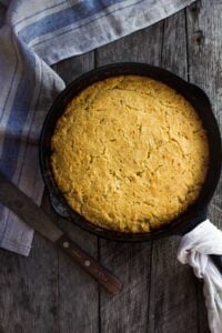 This Cornbread recipe is homey, delicious, and full of wholesome cornmeal flavor with an irresistible crusty edge.  Bake it in a skillet or baking dish and it's ready in just 35 minutes! Perfect for serving with soups, chili's, stews. Vegan-Adaptable (see recipe notes!). 