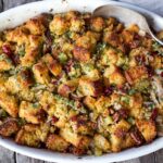 Vegetarian Cornbread Stuffing with Fennel Bulb, Dried Cranberries, and Toasted Pecans is richly flavored and soul comforting. The perfect addition to your holiday table. This recipe can easily be made a day ahead of baking! Vegetarian and Gluten Free adaptable.