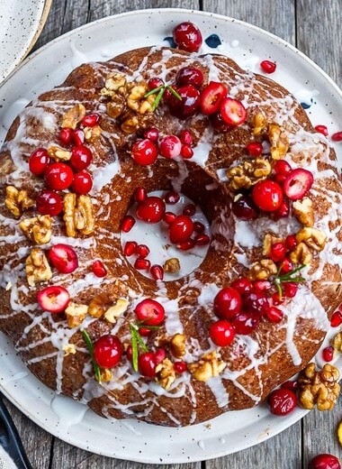 Vegan Cranberry Cake scented with orange and toasty walnuts has a light and tender crumb with just the right balance of sweet and tart.  Festive and delicious, a perfect holiday dessert!