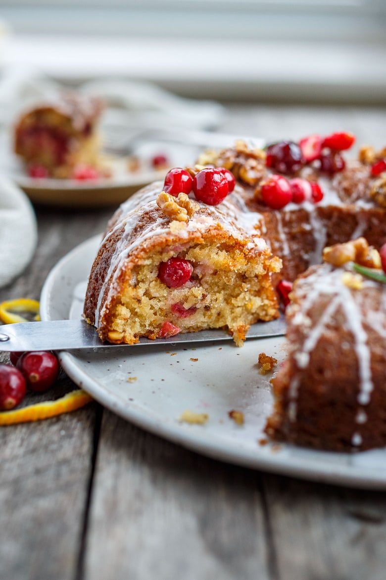 Vegan Cranberry Cake scented with orange and toasty walnuts has a light and tender crumb with just the right balance of sweet and tart.  Festive and delicious, a perfect holiday dessert!