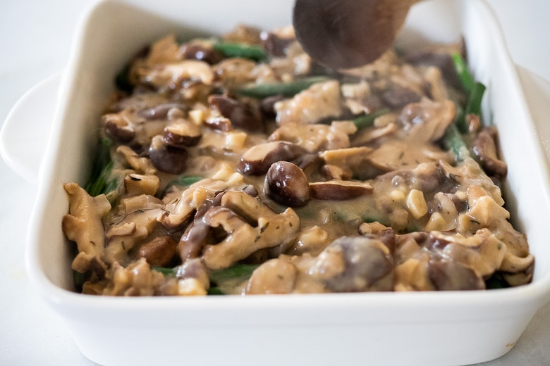 spreading out the vegan mushroom sauce 