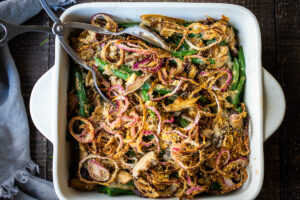 This healthy Green Bean Casserole is made with fresh green beans, oven-baked crispy shallots, and a creamy mushroom sauce that is VEGAN! Easy, healthy and delicious, worthy of the holiday table. 