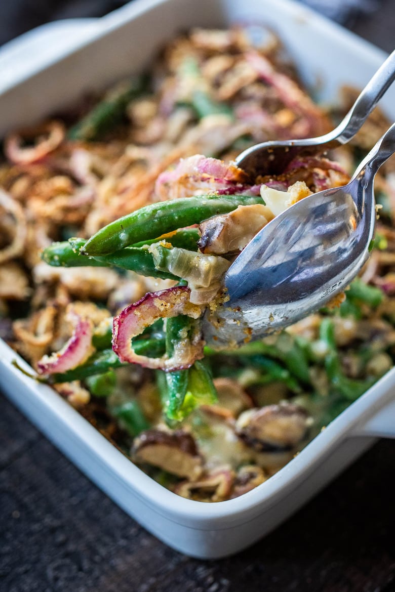 This healthy Green Bean Casserole Recipe is made with fresh green beans, oven-baked crispy shallots, and a creamy mushroom sauce that is VEGAN! Easy, healthy and delicious, worthy of the holiday table. 