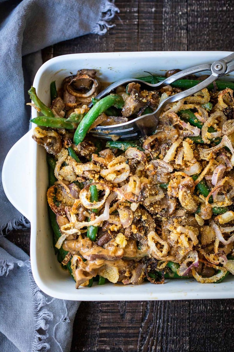 This healthy Green Bean Casserole is made with fresh green beans, oven-baked crispy shallots, and a creamy mushroom sauce that is VEGAN! Easy, healthy and delicious, worthy of the holiday table. 