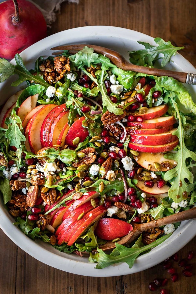 This Pear Salad is the perfect side for a fall gathering or the holiday table. Juicy ripe pears, arugula, spiced nuts, pomegranate seeds, dried currants and gorgonzola are all tossed in a flavorful Vanilla Fig Dressing to create the most delicious balance of flavors. 