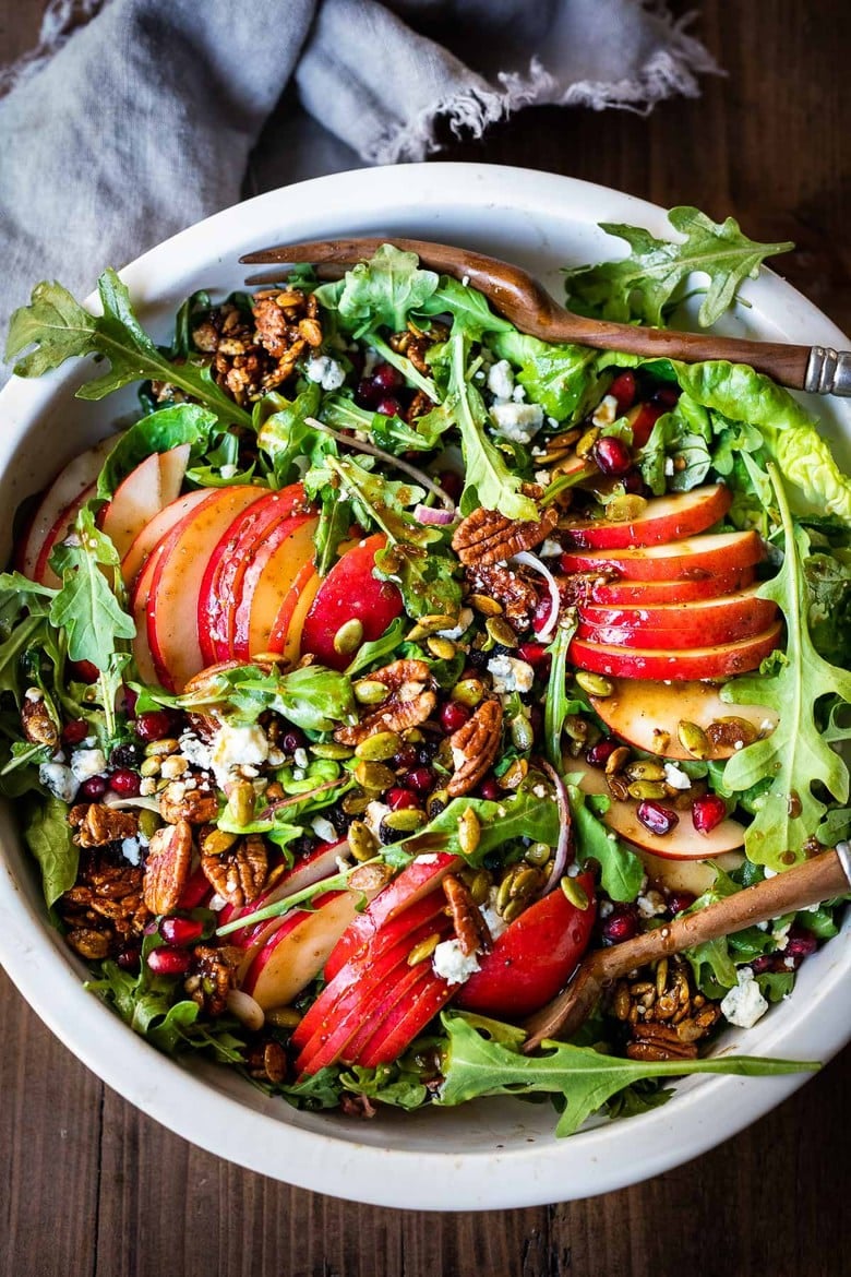 This Pear Salad is over the top potluck recipe perfection. Juicy ripe pears, arugula, spiced nuts, pomegranate seeds, dried currants and gorgonzola are all tossed in a flavorful Vanilla Fig Dressing to create the most delicious balance of flavors. 