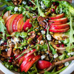This Pear Salad is the perfect side for a fall gathering or the holiday table. Juicy ripe pears, arugula, spiced nuts, pomegranate seeds, dried currants and gorgonzola are all tossed in a flavorful Vanilla Fig Dressing to create the most delicious balance of flavors. 