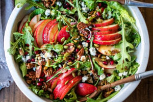 This Pear Salad is the perfect side for a fall gathering or the holiday table. Juicy ripe pears, arugula, spiced nuts, pomegranate seeds, dried currants and gorgonzola are all tossed in a flavorful Vanilla Fig Dressing to create the most delicious balance of flavors. 