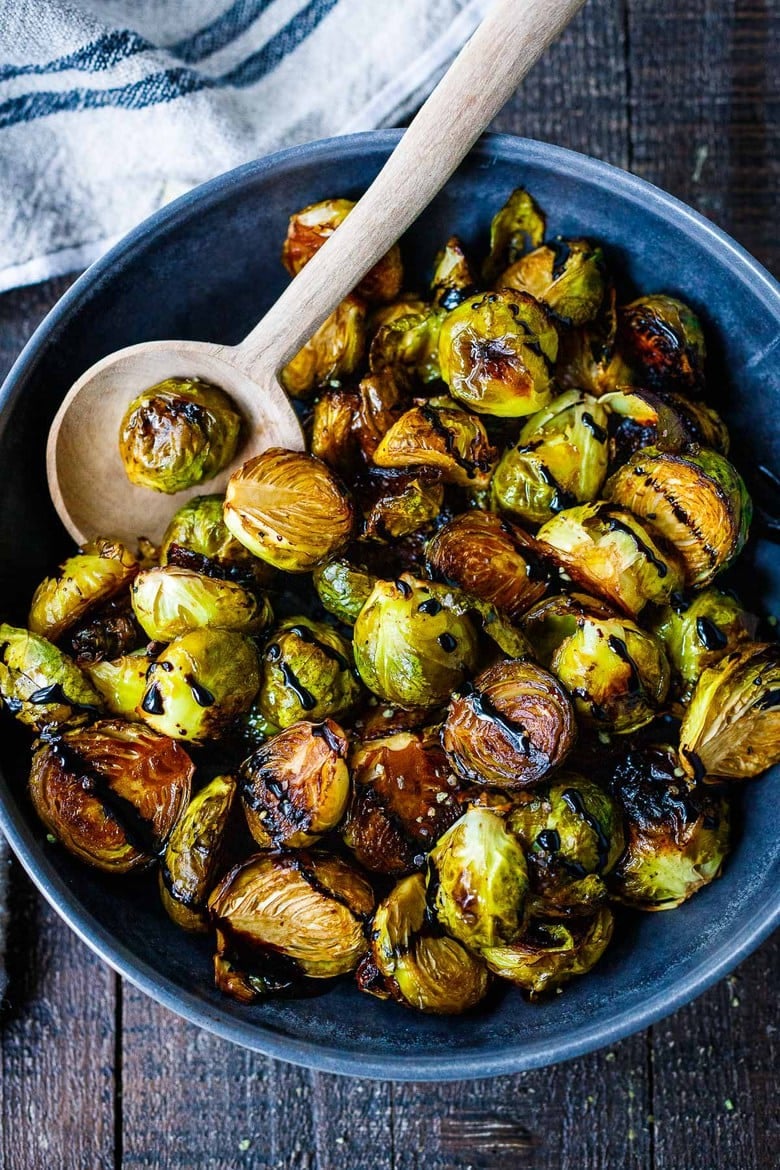 A simple recipe for Roasted Brussels Sprouts with garlic and balsamic- tender, carmelized and full of toasty deep flavor.  An easy vegan side dish ready in 30 minutes! 