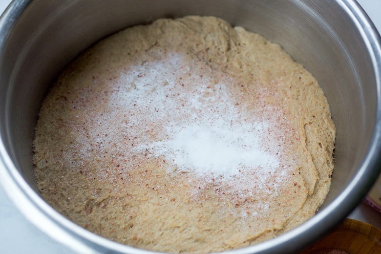 sprinkling baking soda and salt over bowl