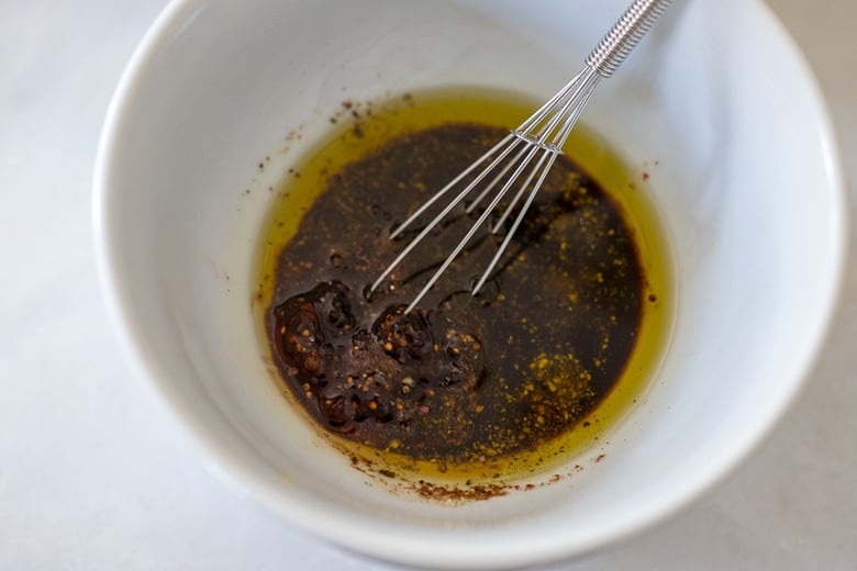 Whisking Fig dressing in a bowl.
