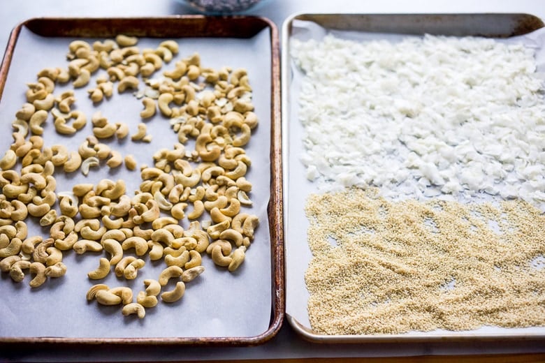 trays of cashews, coconut, and sesame seeds