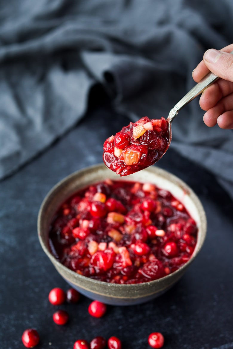 Orange Maple Cranberry Sauce with fresh apple is a bright and healthy addition to your holiday feast!  Easy, fast, and can be made ahead.   Maple-sweetened, and free of refined sugar, vegan and gluten-free! #cranberrysauce