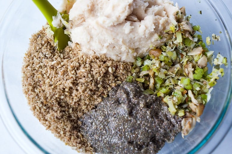 Stirring together bread crumbs, beans, chia seeds, leeks and mushrooms