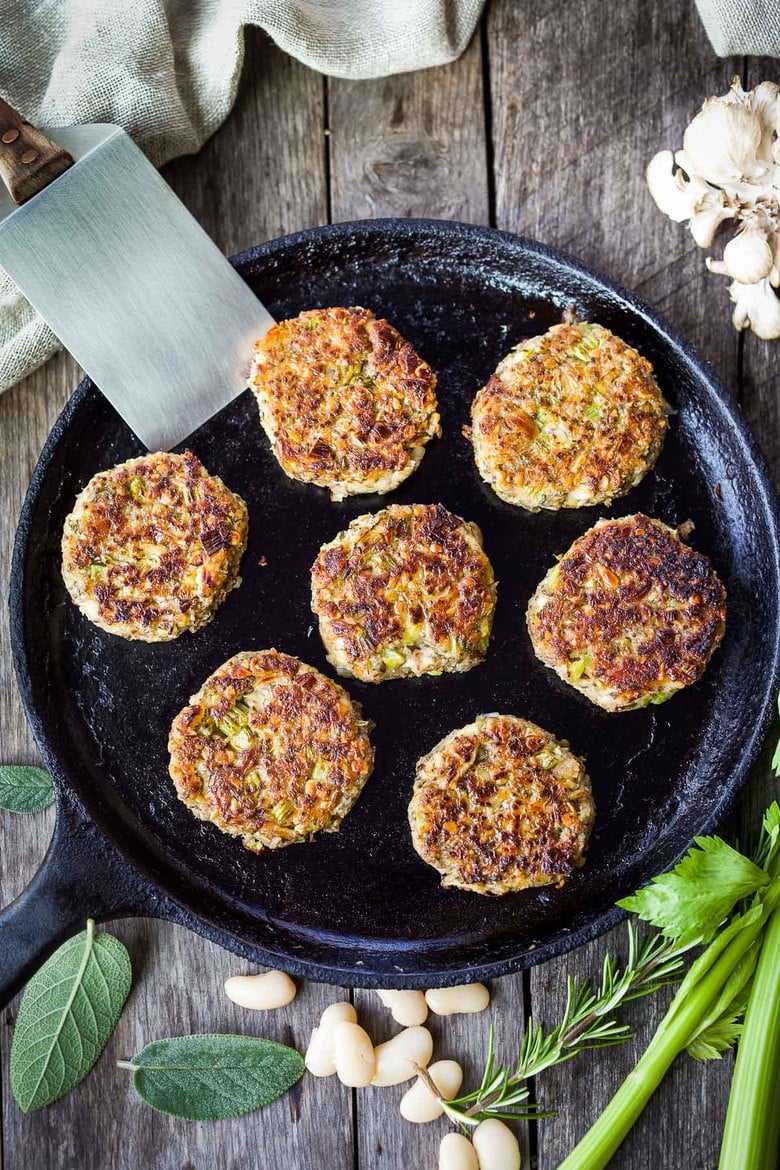 Sagey Leek and White Bean Patties are brimming with all the savory holiday flavors.   Serve them up with mashed potatoes, cranberry sauce and mushroom gravy for a deliciously satisfying vegan feast!  Perfect for making ahead time.  Gluten-free adaptable.