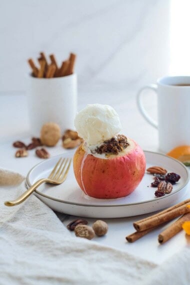 These Baked Apples are a cozy, fall dessert (or delicious homey breakfast!) Filled with toasted nuts and dates, dried cherries, cinnamon, and orange zest, they are maple-sweetened with no refined sugar! This baked apples recipe is vegan and gluten-free.
