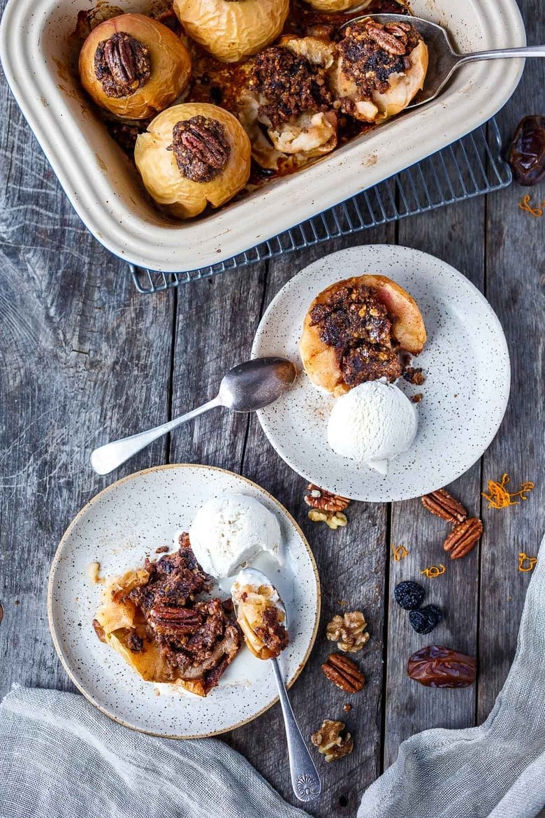 Baked Apples are a cozy comforting dessert. Filled with pecans, walnuts, dates, dried cherries,  cinnamon, and orange zest, they are maple-sweetened, with no refined sugar, vegan and gluten-free! This baked apples recipe is vegan and gluten-free. 