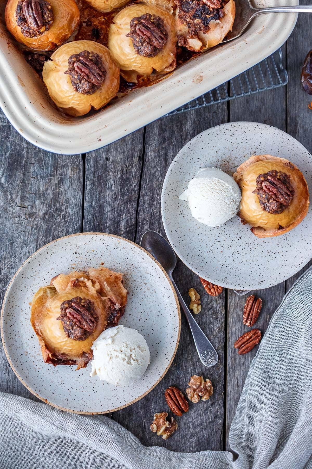 Baked Apples on serving plates with ice cream.