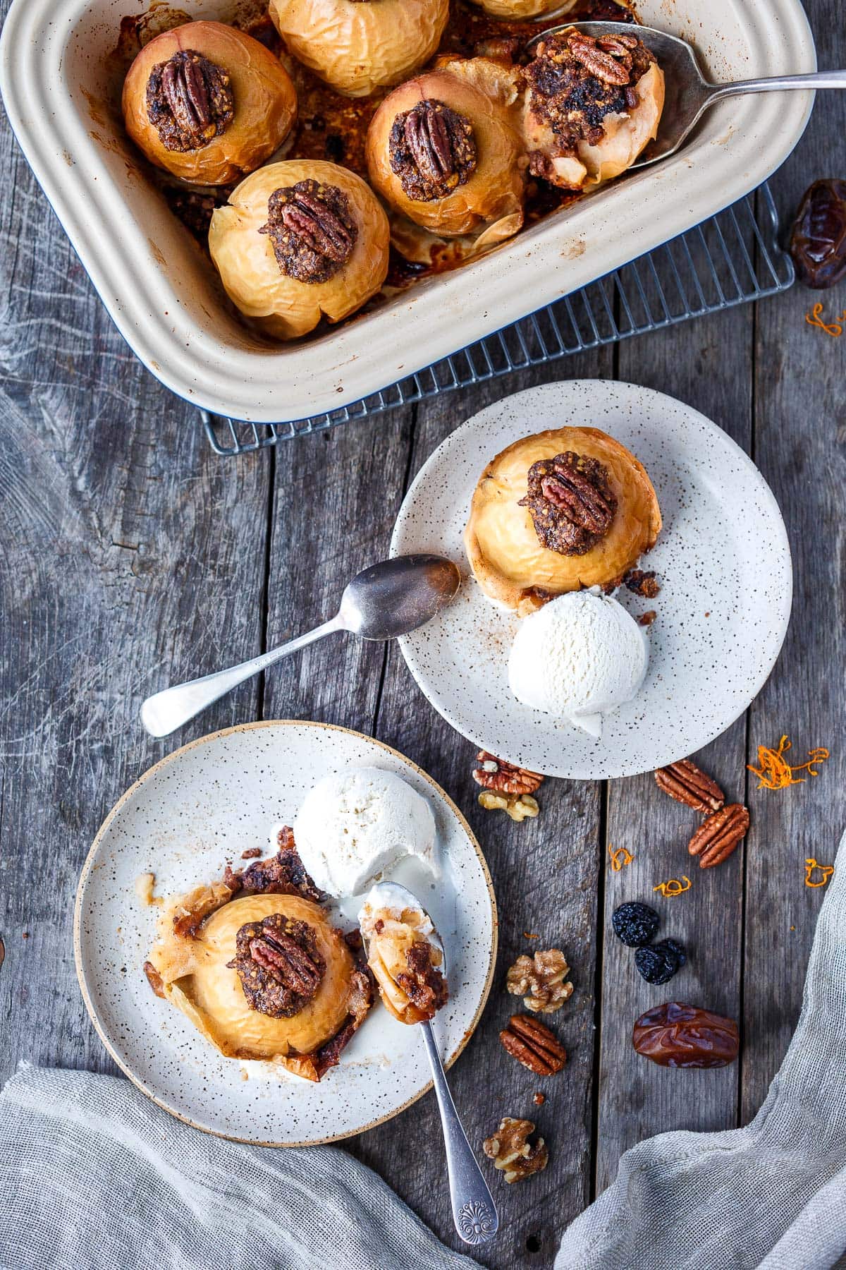 These Baked Apples are a cozy, fall dessert (or delicious homey breakfast!) Filled with toasted nuts and dates, dried cherries, cinnamon, and orange zest, they are maple-sweetened with no refined sugar! This baked apples recipe is vegan and gluten-free.Â