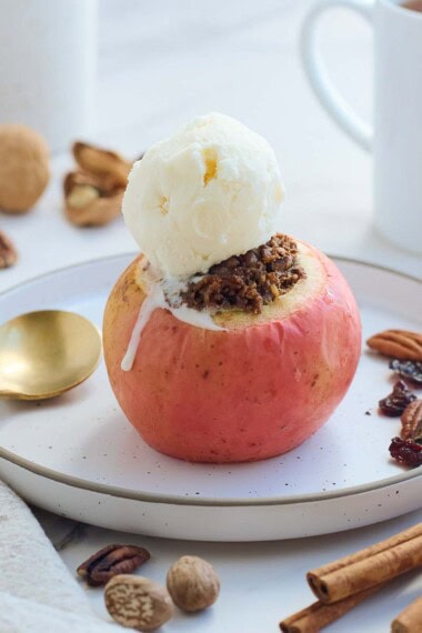 These Baked Apples are a cozy, fall dessert (or delicious homey breakfast!) Filled with toasted nuts and dates, dried cherries, cinnamon, and orange zest, they are maple-sweetened with no refined sugar! This baked apples recipe is vegan and gluten-free.