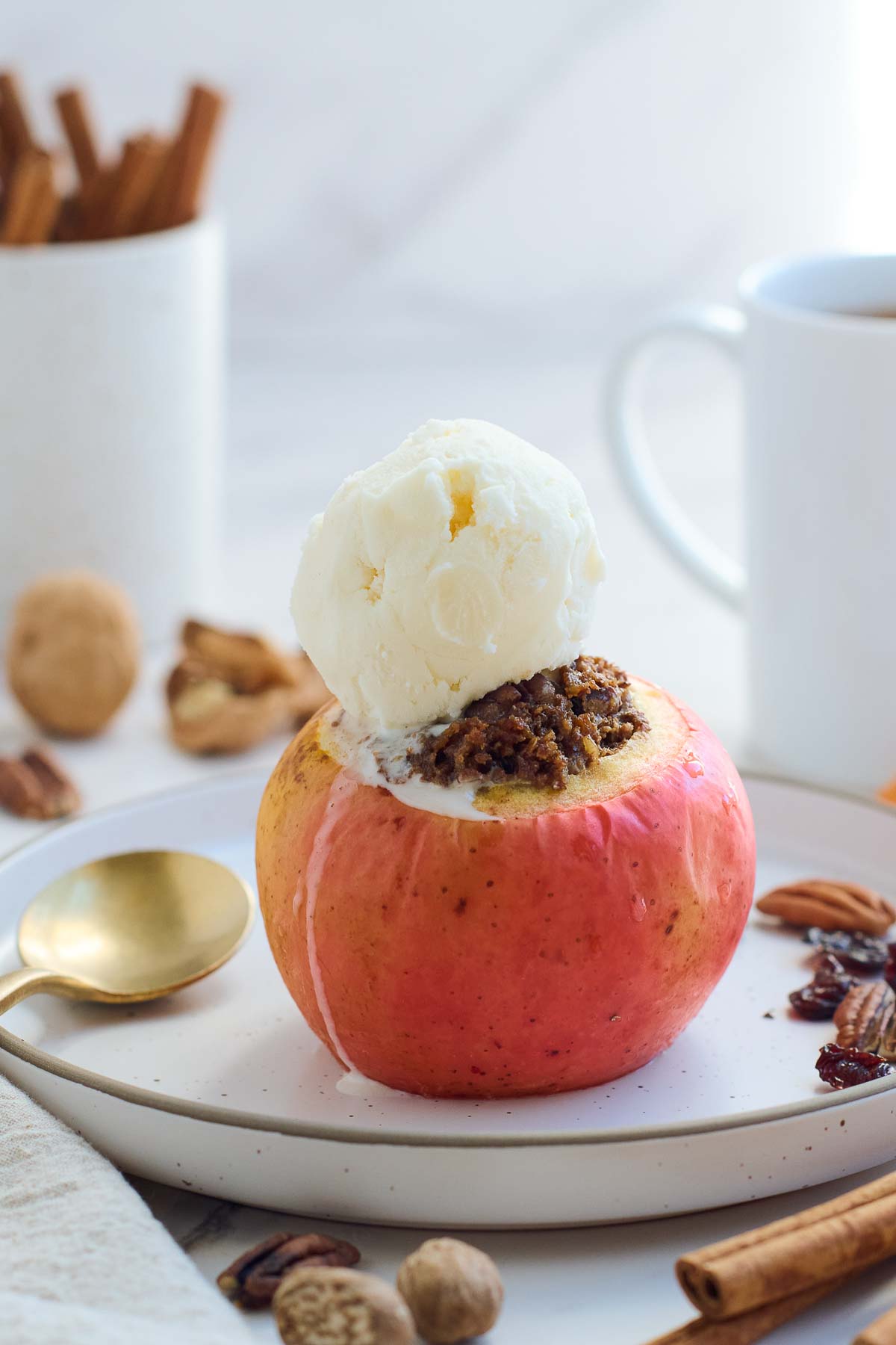 These Baked Apples are a cozy, fall dessert (or delicious homey breakfast!) Filled with toasted nuts and dates, dried cherries, cinnamon, and orange zest, they are maple-sweetened with no refined sugar! This baked apples recipe is vegan and gluten-free.
