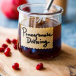 Bright and tangy Pomegranate Vinaigrette is a festive vegan salad dressing recipe made with reduced pomegranate juice , shallots and orange zest, perfect for holiday salads.