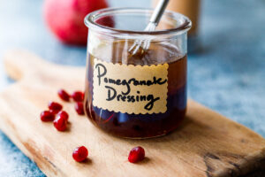 Bright and tangy Pomegranate Vinaigrette is a festive vegan salad dressing recipe made with reduced pomegranate juice , shallots and orange zest, perfect for holiday salads.