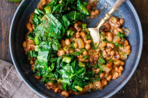 Just in time for New Years Day, here's a tasty, lighter recipe for Smokey Black-Eyed Peas served up with Garlicky Collard Greens and Cornbread- to ensure luck, prosperity and good fortune in the coming year. Vegan and GF.