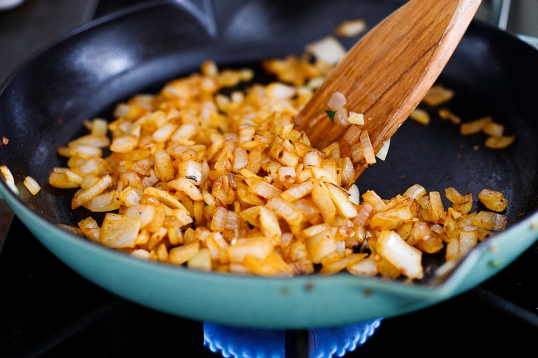 adding onion and garlic to the pan