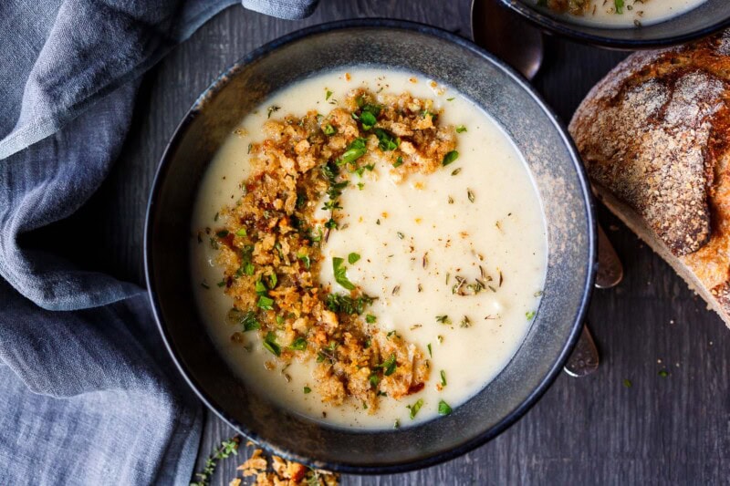 Cauliflower Cheddar soup with toasted bread crumbs in a bowl.