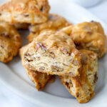Golden Maple Pecan Scones are flakey, buttery, and tender with a delicious nutty flavor from the toasty pecans and real maple syrup. A fun bake, perfect for special gatherings, and holiday mornings.