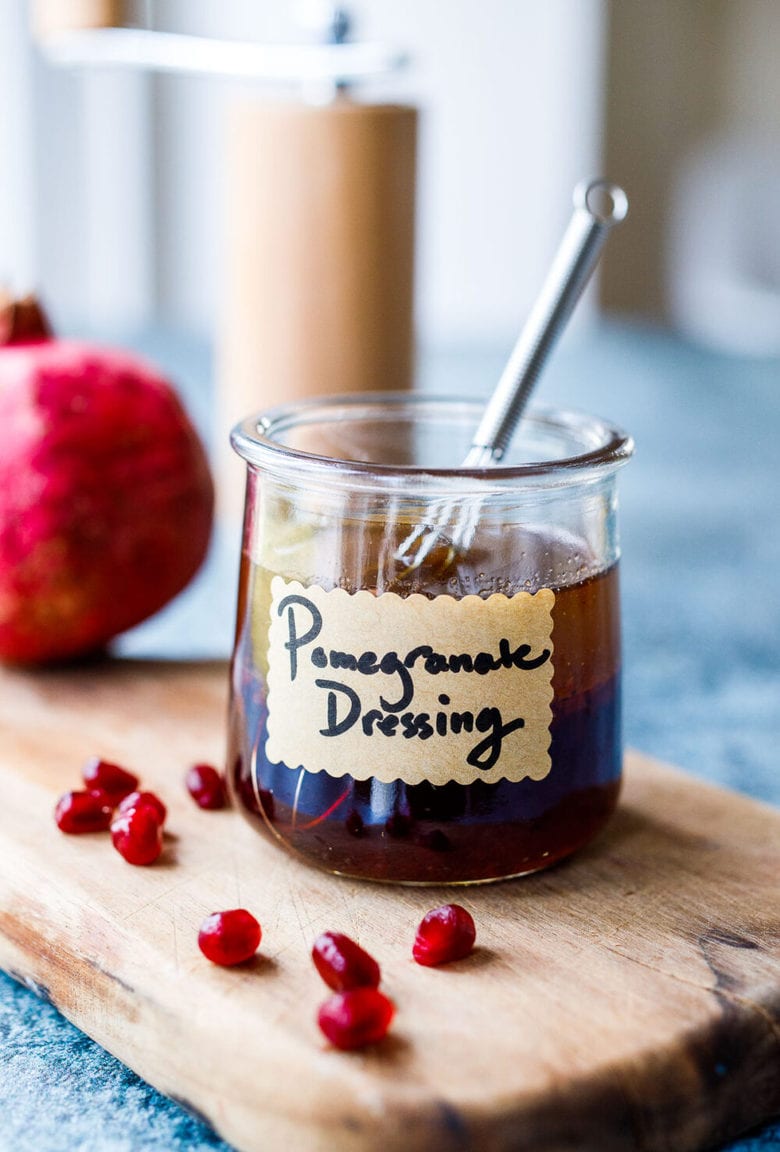 Bright and tangy Pomegranate Vinaigrette is a festive vegan salad dressing recipe made with reduced pomegranate juice , shallots and orange zest, perfect for holiday salads.