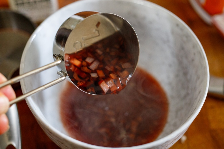 whisk dressing ingredients in a bowl