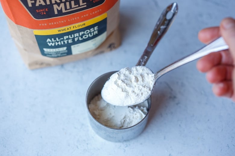 scooping flour into cup