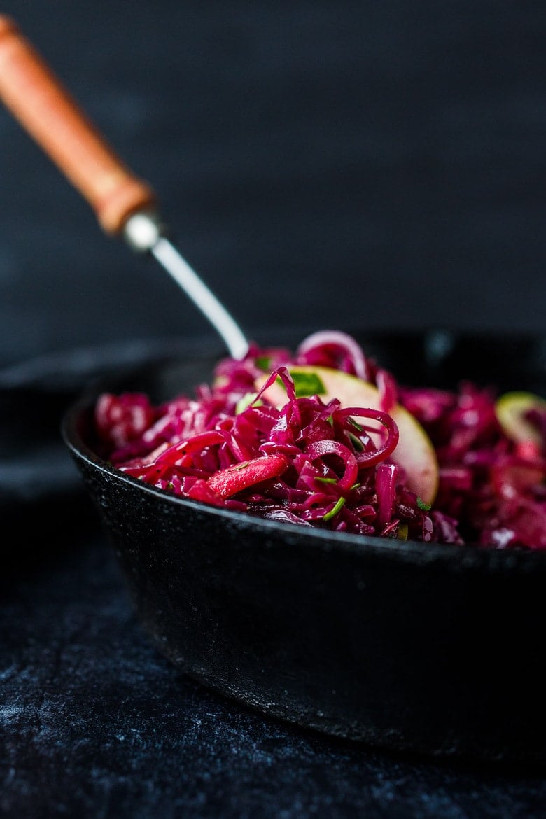 Warm Red Cabbage Slaw with tart apples is a delicious winter side dish with a lovely sweet and sour balance.  A  healthy complement to rich holiday dishes.  Simple to make.  Vegan and gluten-free.