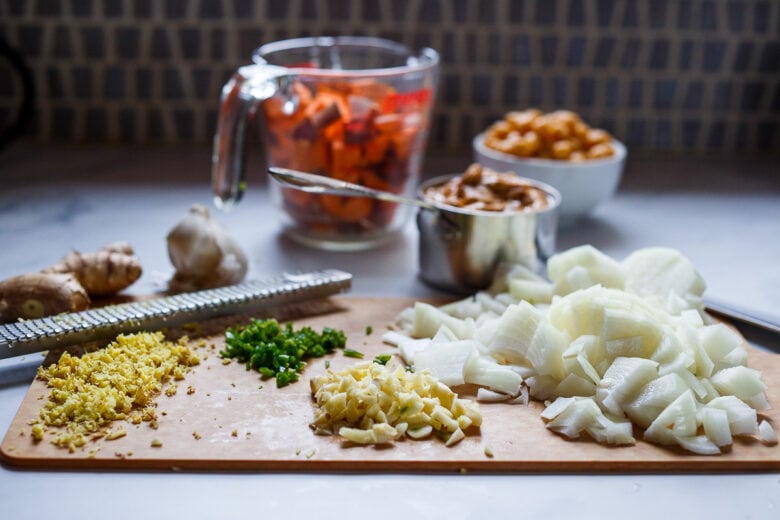 Cubed yams, chop, dice, and minced onion, ginger, garlic, and serrano chili for African peanut soup.