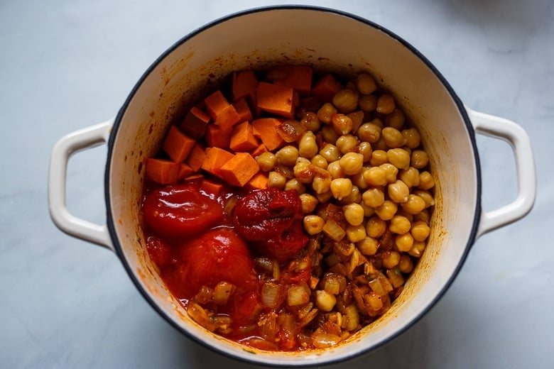 Adding yams or sweet potatoes, chickpeas and tomatoes to the Peanut Soup.