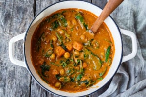 Spicy African Peanut Soup is made with everyday pantry items that transform into a lively soup with full bodied flavors. Richly spiced with ginger, garlic, and chilies in a creamy peanut tomato base, this protein-rich soup is one you will crave.  Vegan and Gluten-free!