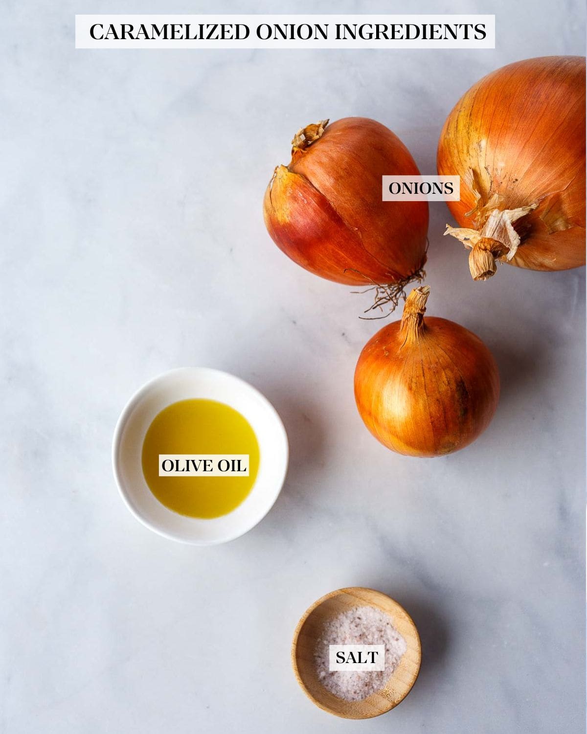 Ingredients for caramelized onions: onions, olive oil, salt on a marble background.