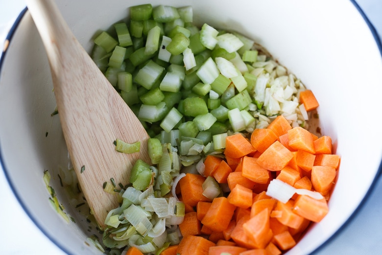 adding veggies into leeks