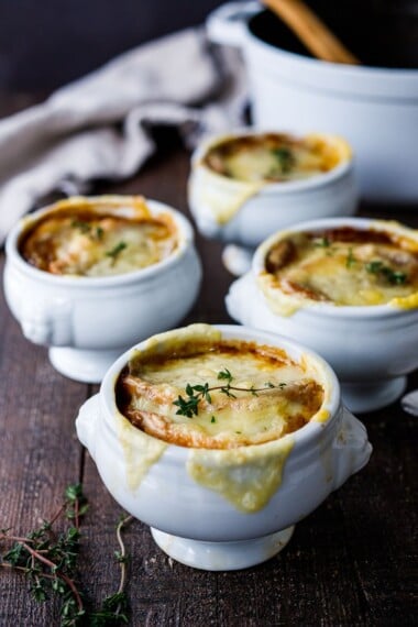 A cozy, comforting, classic recipe for French Onion Soup with caramelized onions in rich deep broth topped with toasty croutons and melted gruyere.  Vegan and Vegetarian Adaptable! #frenchonionsoup