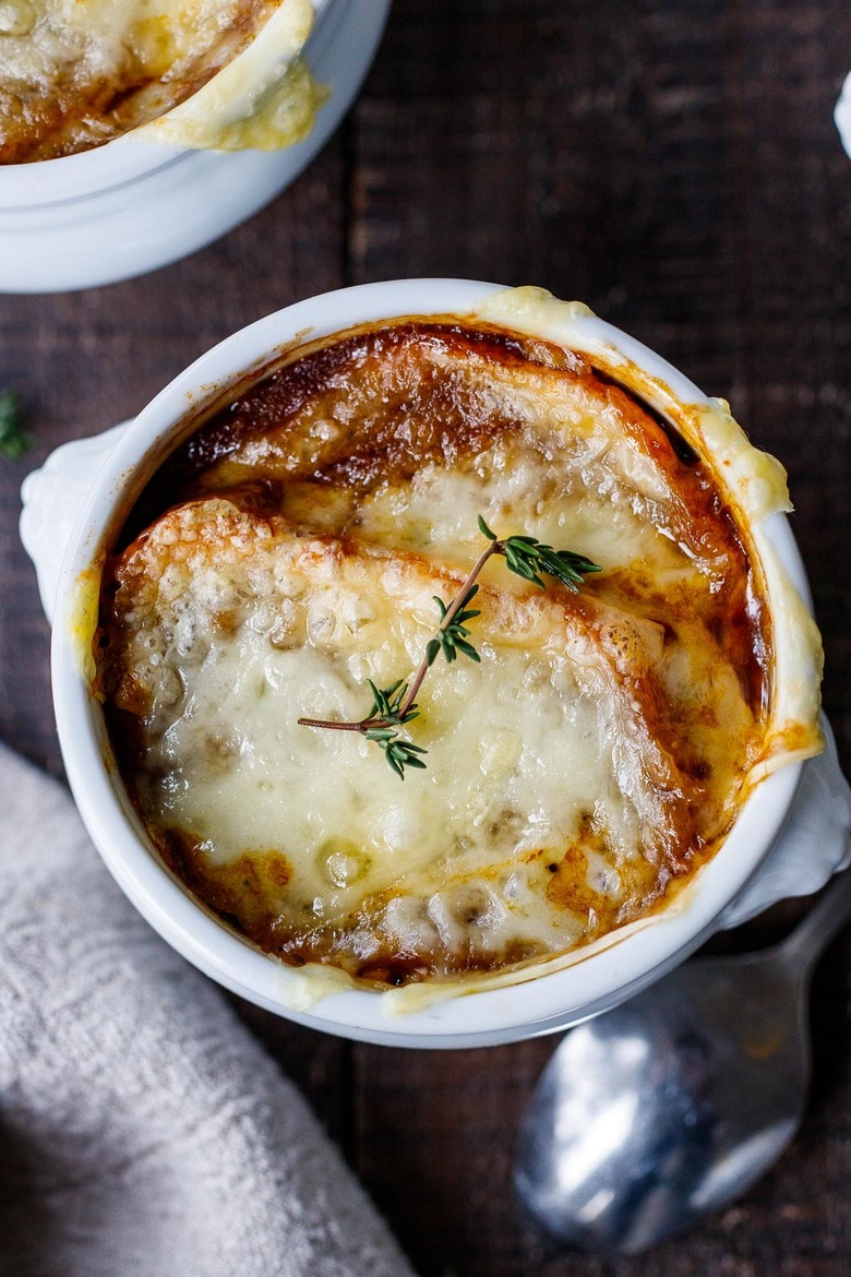 A cozy, comforting, classic recipe for French Onion Soup with caramelized onions in rich deep broth topped with toasty croutons and melted gruyere.  Vegan and Vegetarian Adaptable! #frenchonionsoup