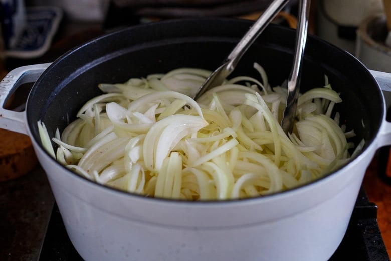 Cook onions in heavy bottom pot or Dutch Oven with butter or olive oil and salt. Toss.