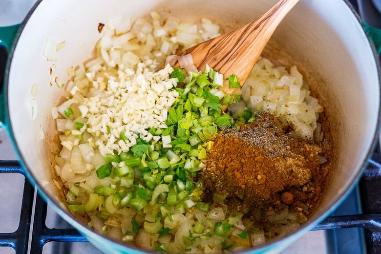 Adding spices, celery, and garlic to the onions for harira.
