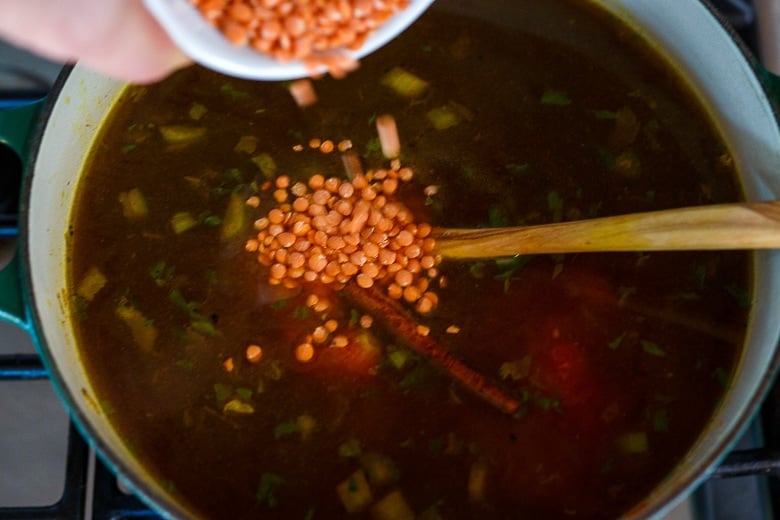 Adding broth and lentils to Harira.