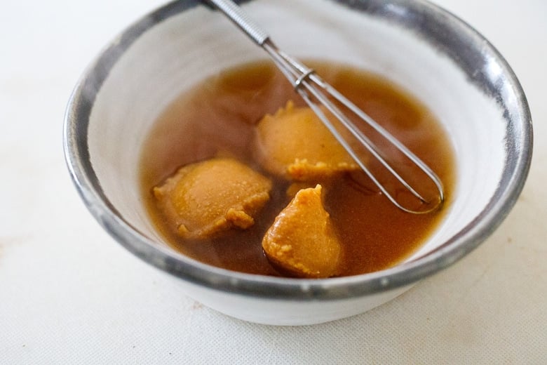 pour warm broth over the miso paste