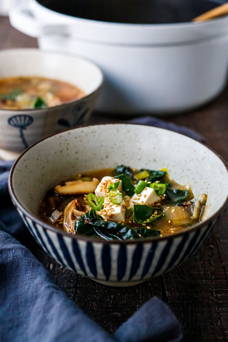20-minute Miso Soup Recipe with shiitake mushrooms, wilted greens, and tofu makes for a fast and easy weeknight dinner. Full of flavor and nutrients it is highly nourishing while remaining light and lean. Vegan and GF adaptable. 